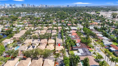 an aerial view of a house with a yard and potted plants
