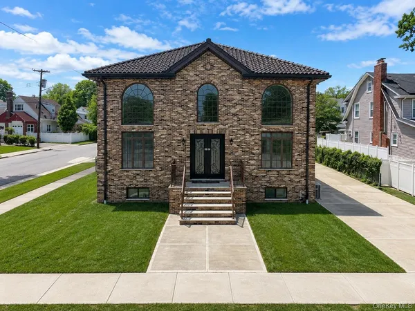 a front view of a house with garden