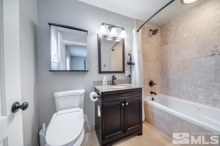 1640 Davidson Way Reno, NV 89509 - Photo 11 of 25 a bathroom with a toilet sink and mirror