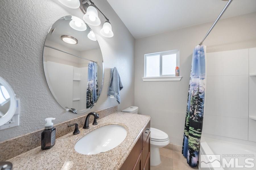 1640 Davidson Way Reno, NV 89509 - Photo 13 of 25 a bathroom with a sink a toilet and a mirror