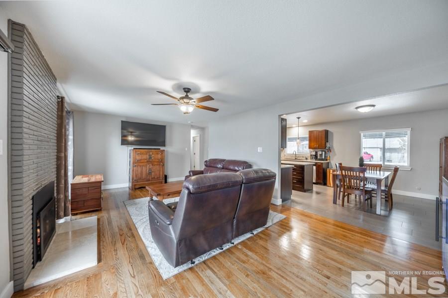 1640 Davidson Way Reno, NV 89509 - Photo 5 of 25 a living room with furniture and a dining table with wooden floor