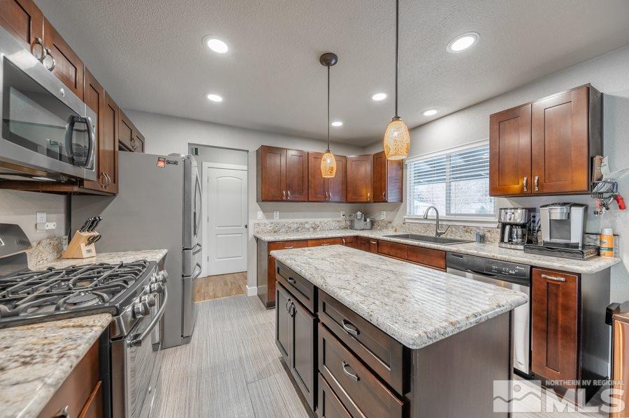 1640 Davidson Way Reno, NV 89509 - Photo 9 of 25 a kitchen with a stove sink and microwave