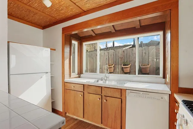 a view of a livingroom with a ceiling fan and window