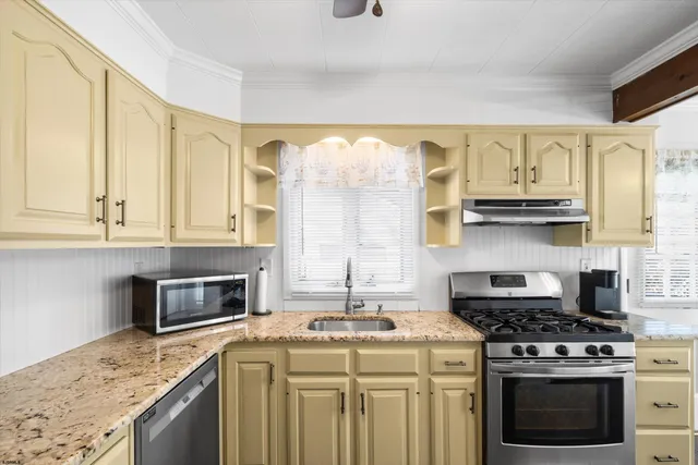 a kitchen with stainless steel appliances a refrigerator sink and cabinets