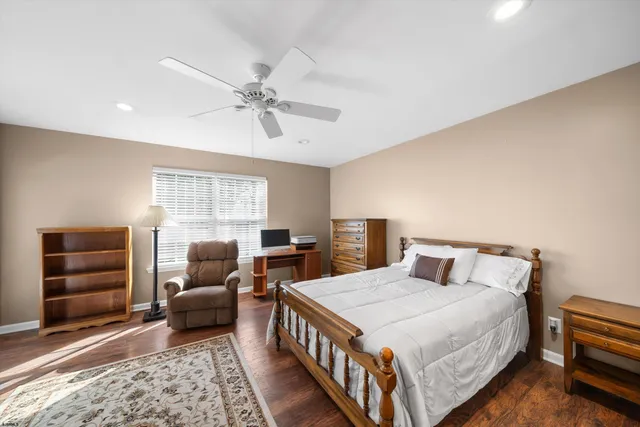 a bedroom with a large bed and a flat screen tv