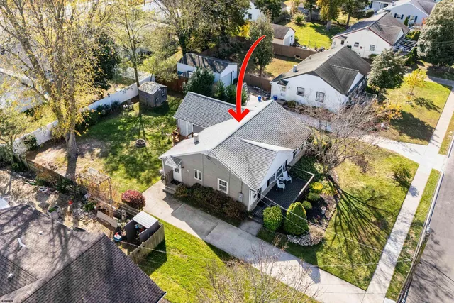 an aerial view of a house with a yard and potted plants