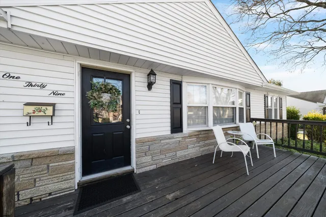 a living room with furniture a flat screen tv and wooden floor