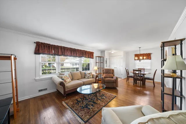 a kitchen with stainless steel appliances a sink dishwasher stove and white cabinets with wooden floor