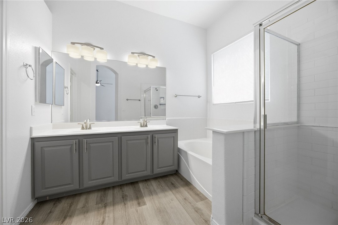 193 Oella Ridge Court Henderson, NV 89012 - Photo 5 of 32 Dual vanities and a spacious glass-enclosed shower highlight this refreshed bathroom.