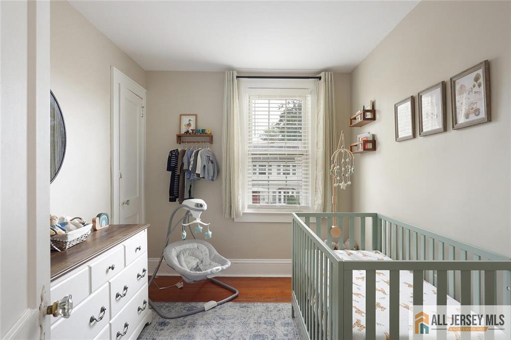 23 Edgegrove Street Edison, NJ 08837 - Photo 19 of 34 a bedroom with furniture and wooden floor