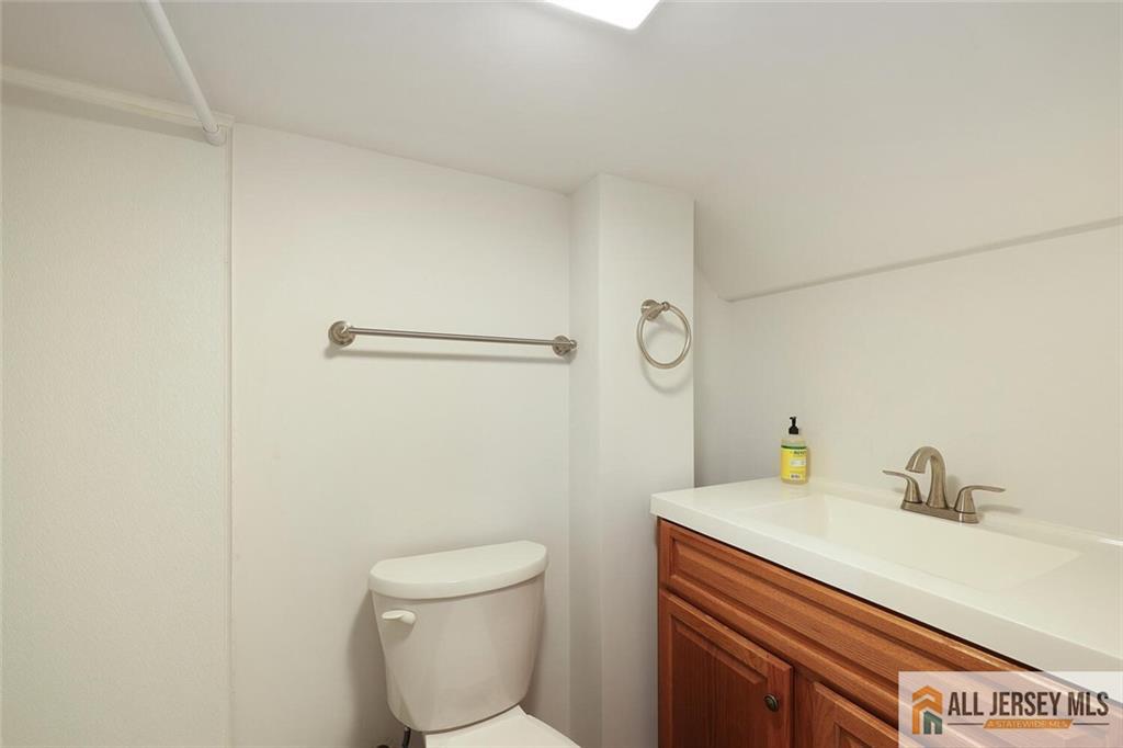 23 Edgegrove Street Edison, NJ 08837 - Photo 24 of 34 a bathroom with a sink a toilet and mirror
