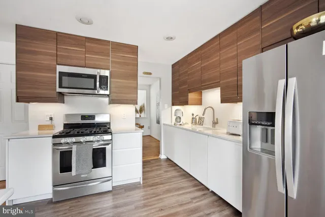 a kitchen with stainless steel appliances a stove microwave and a refrigerator