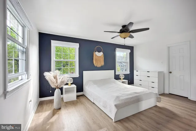 a bedroom with a large bed and a window