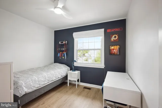 a bedroom with a bed and a window