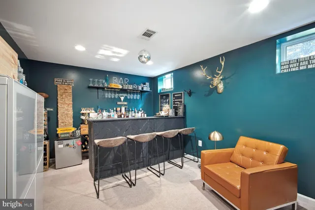 a living room with furniture and a wall painting