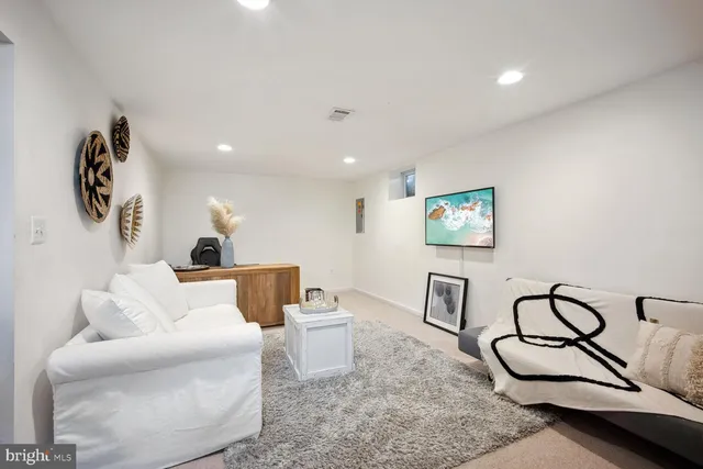a living room with furniture and white walls