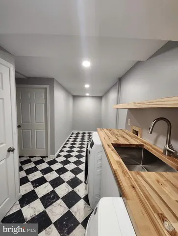 a kitchen with a sink a refrigerator and cabinets