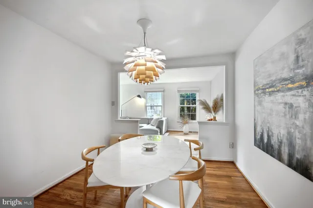 a view of a dining room with furniture wooden floor and chandelier