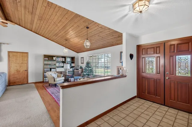 a living room with furniture and a clock