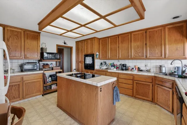 a bedroom with furniture and a large window