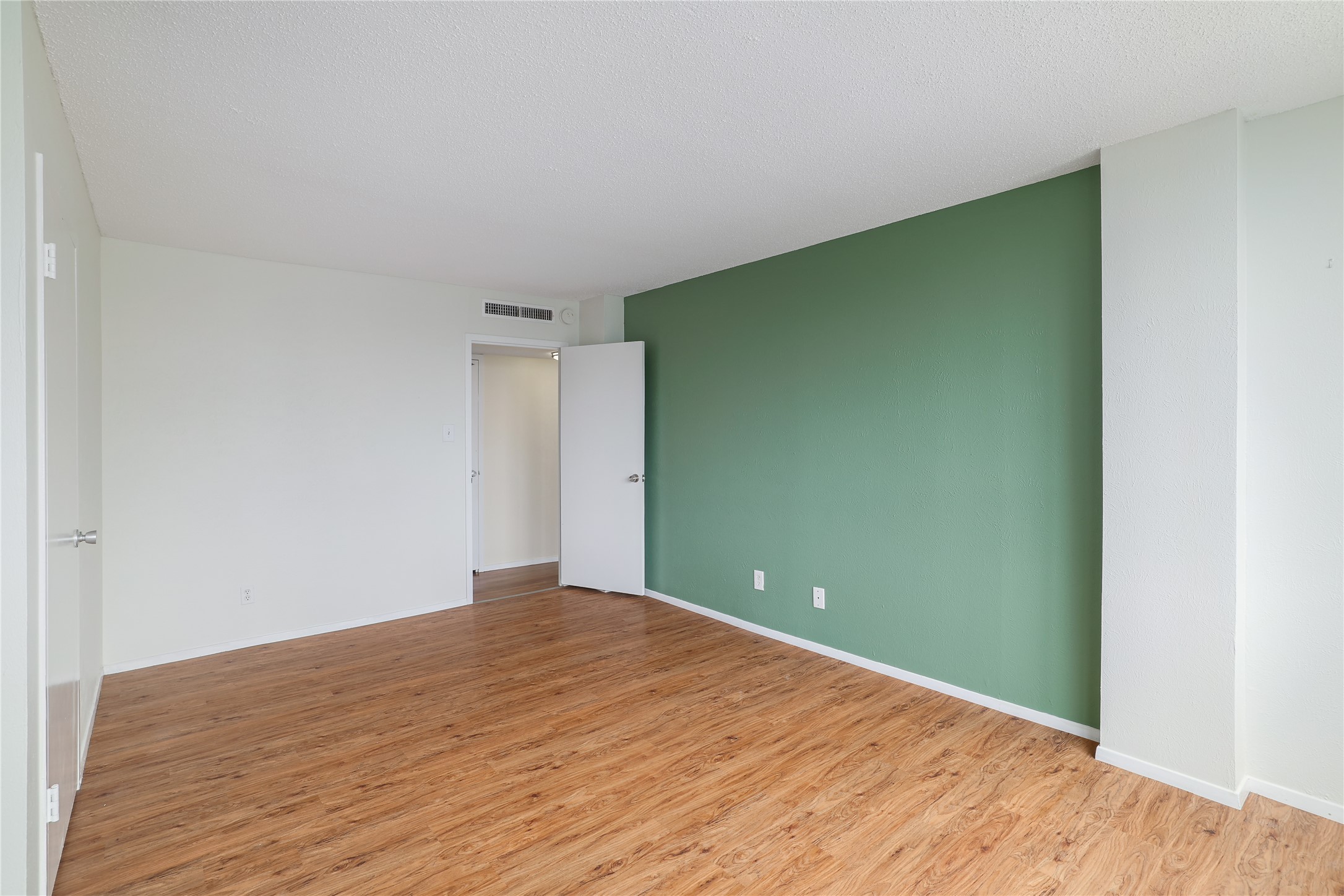 1800 Lavaca Street, Unit A508 Austin, TX 78701 - Photo 22 of 25 This room features a distinctive accent wall in a muted green hue