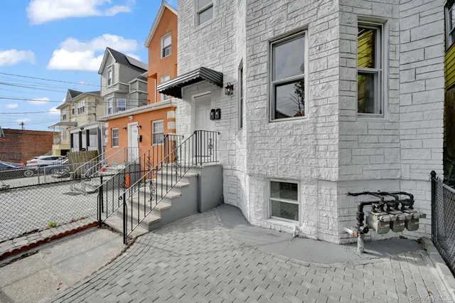a view of a brick house with many windows