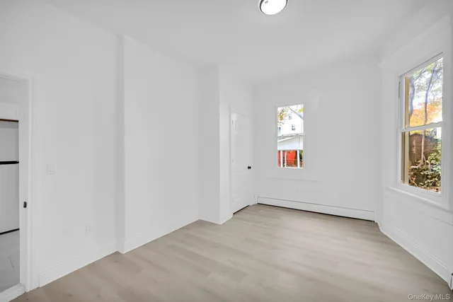 a room with a white stove a refrigerator a sink and cabinets