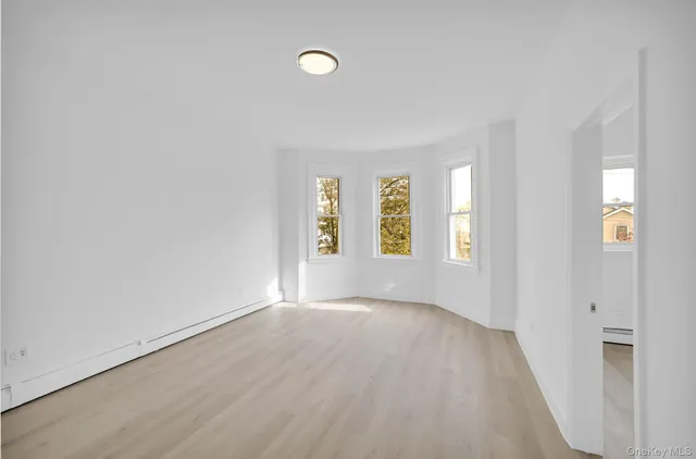 a view of a room with wooden floor