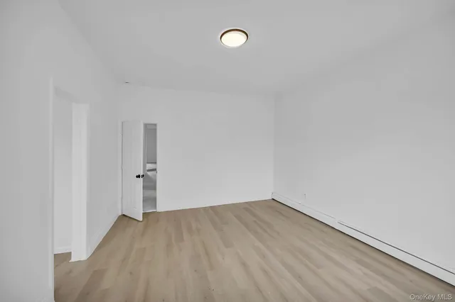 an empty room with windows and closet