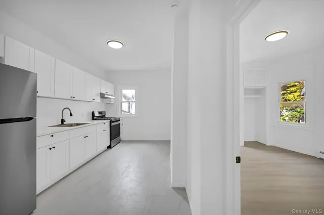 a kitchen with granite countertop a sink and a stove top oven