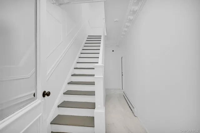 a kitchen with white cabinets and appliances