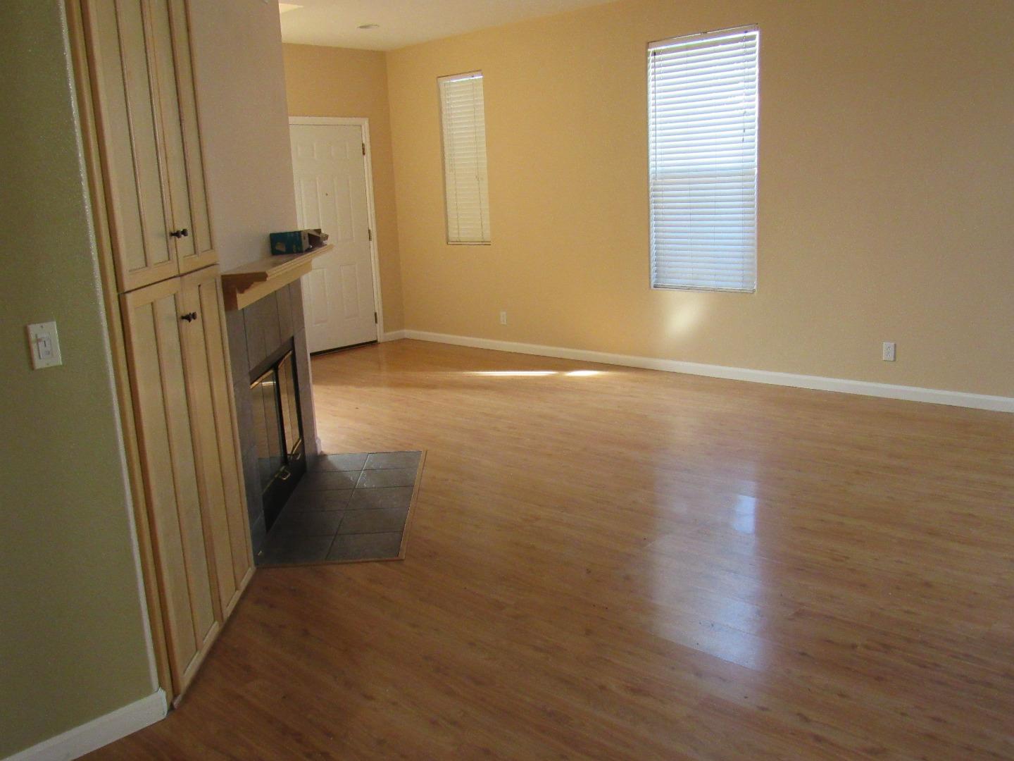 8952 Del Rio Circle Gilroy, CA 95020 - Photo 3 of 8 an empty room with wooden floor and a window