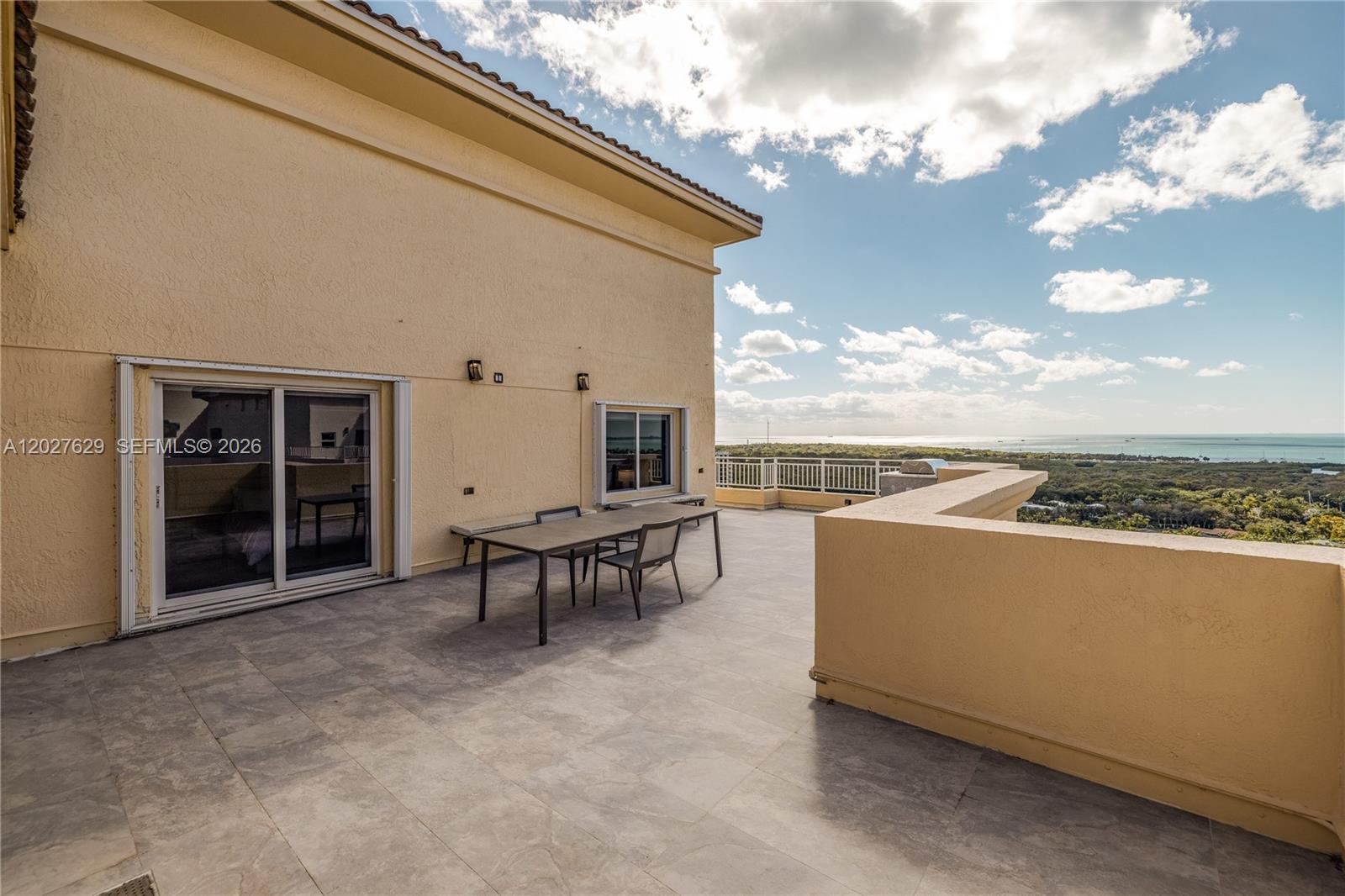 799 Crandon Boulevard, Unit PH8 Key Biscayne, FL 33149 - Photo 31 of 47 a view of a terrace with couches and a table