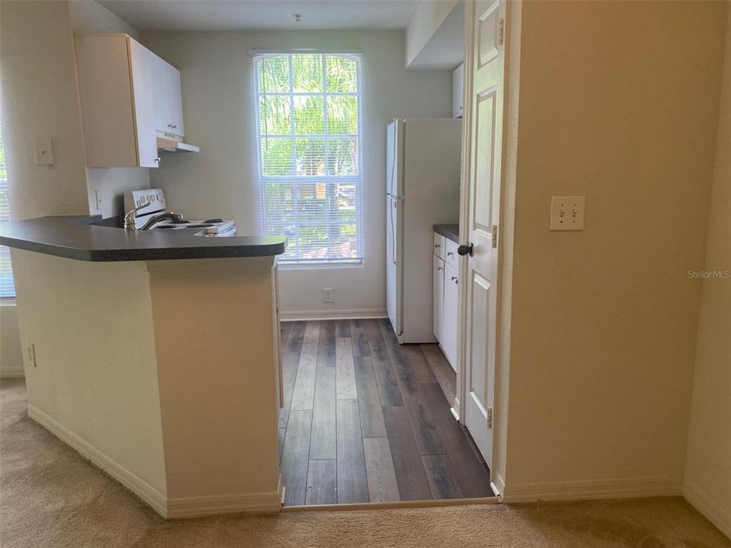 6424 Raleigh Street, Unit 3114 Orlando, FL 32835 - Photo 11 of 11 a view of a livingroom with wooden floor and a window