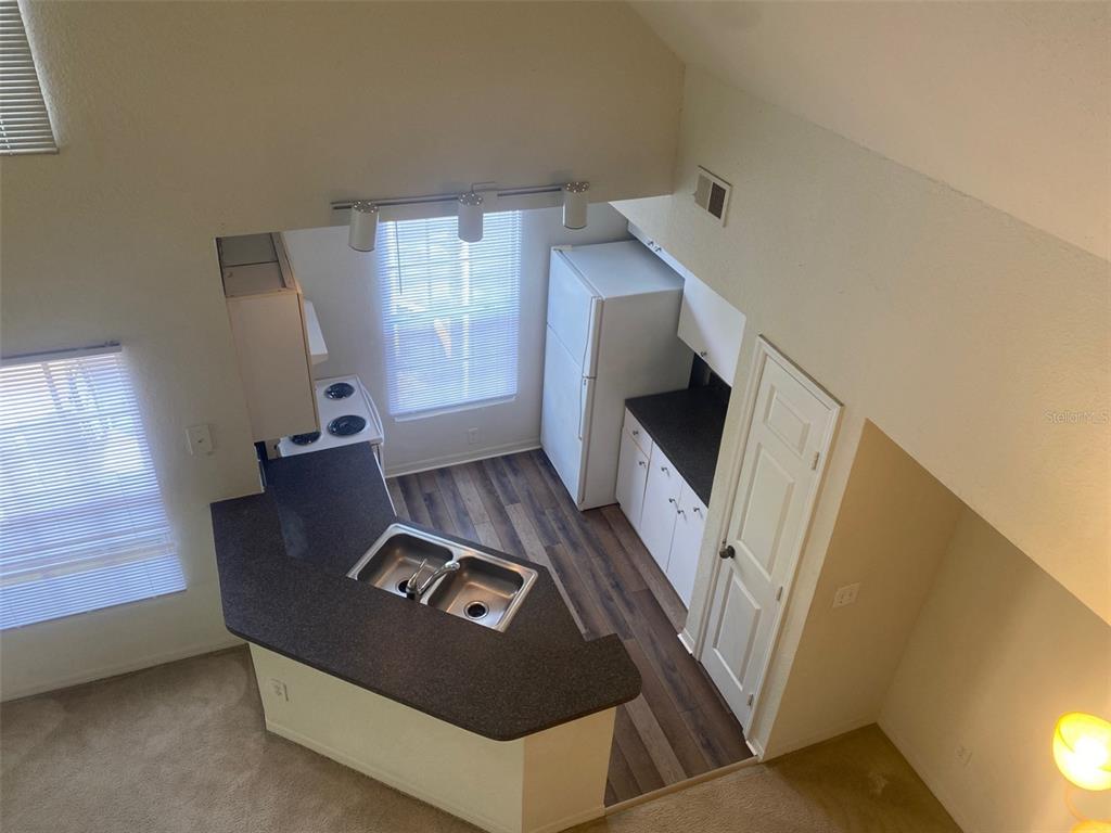 6424 Raleigh Street, Unit 3114 Orlando, FL 32835 - Photo 9 of 11 a living room with furniture and a fireplace