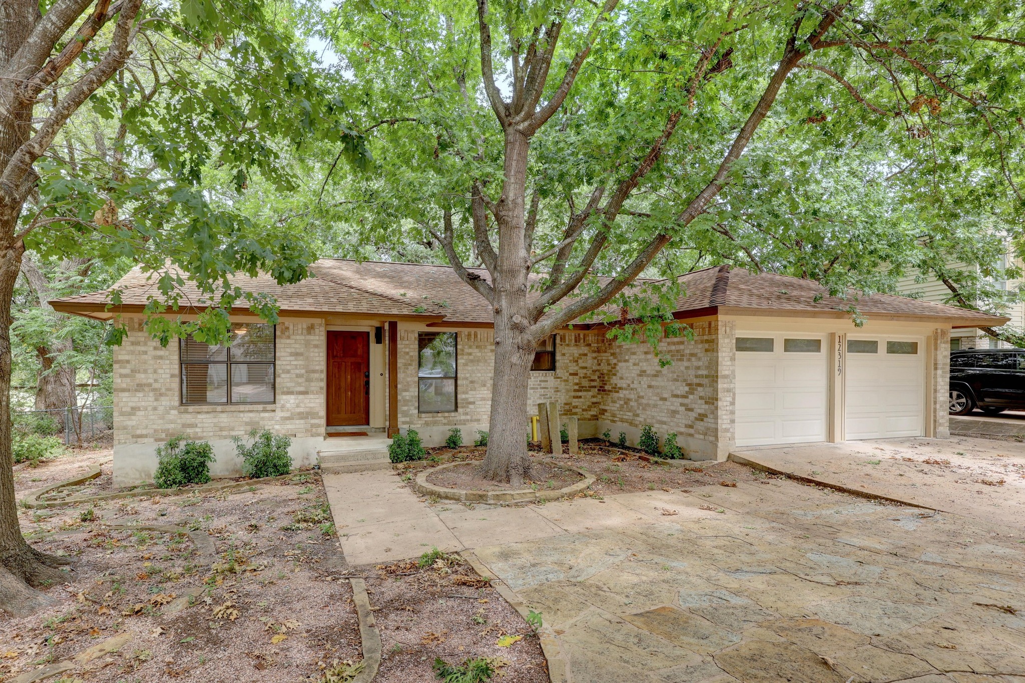 a front view of a house with a yard and a garage