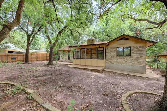 a view of dirt yard with a tree