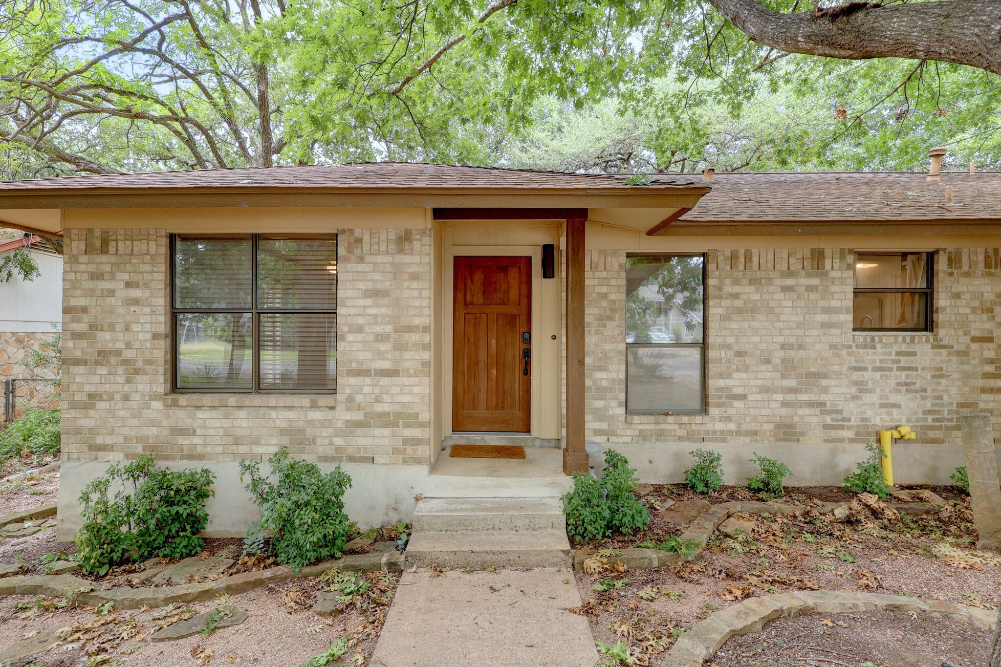 12319 Double Tree Lane Austin, TX 78750 - Photo 2 of 27 a front view of a house with garden