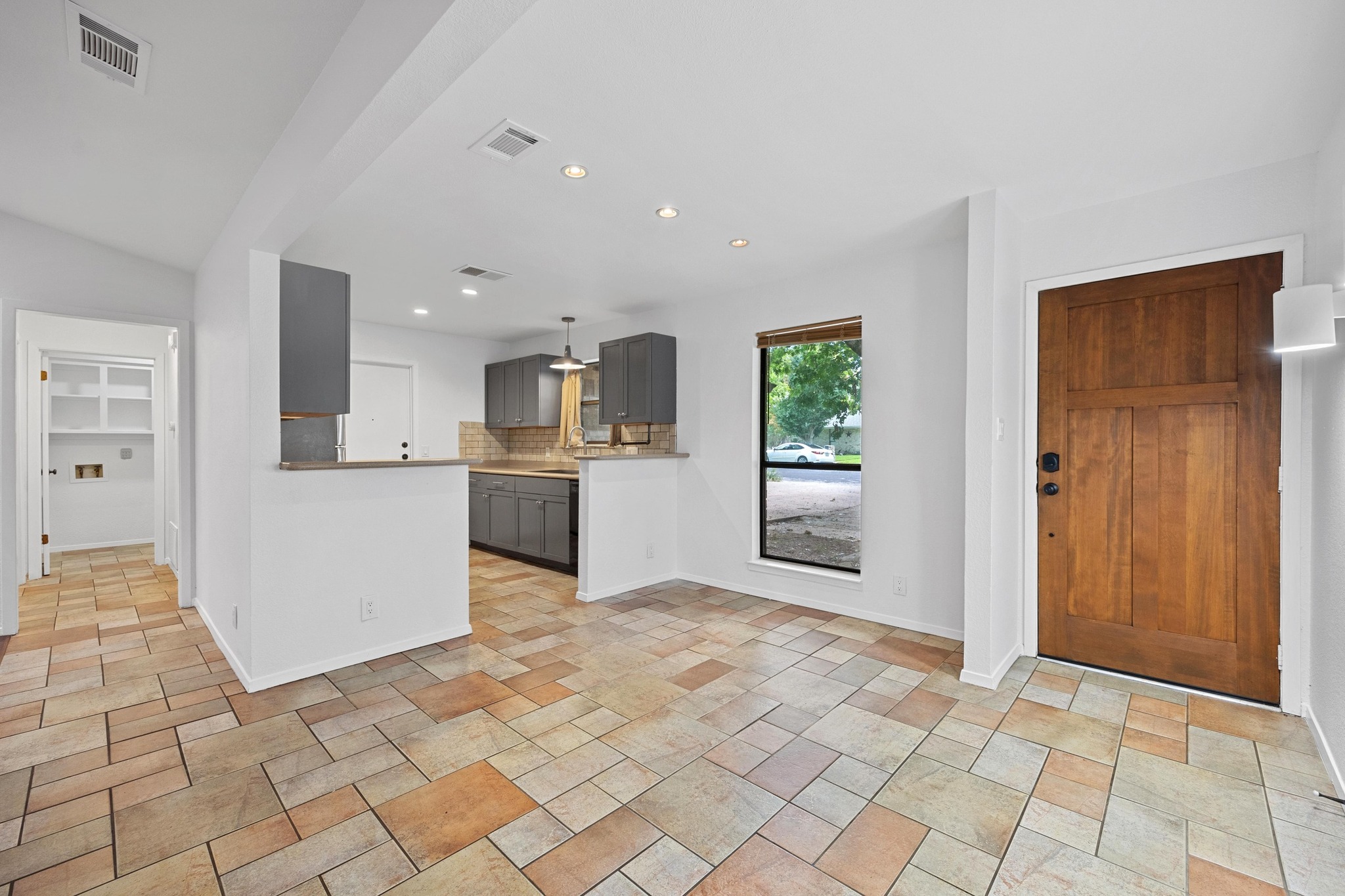 12319 Double Tree Lane Austin, TX 78750 - Photo 4 of 27 a view of a kitchen with wooden floor and a refrigerator