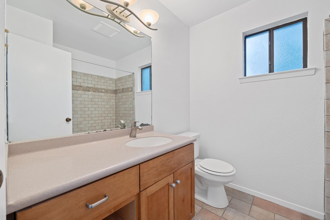 12319 Double Tree Lane Austin, TX 78750 - Photo 10 of 27 a bathroom with a sink a toilet and shower