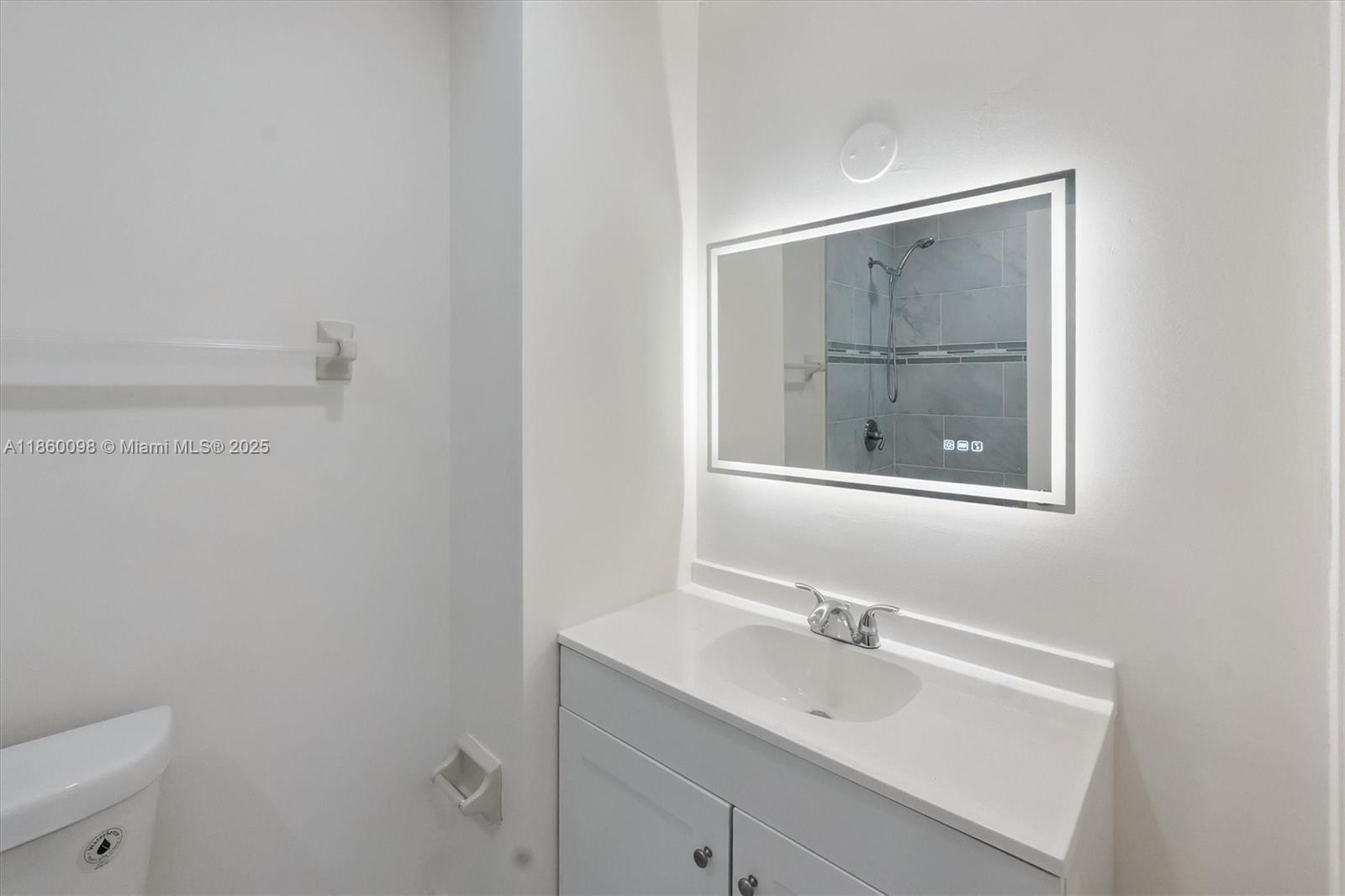 5975 Southwest 137th Avenue, Unit 702 Miami, FL 33183 - Photo 13 of 21 a bathroom with a sink and a mirror