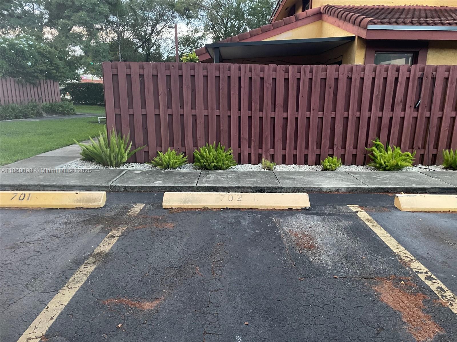 5975 Southwest 137th Avenue, Unit 702 Miami, FL 33183 - Photo 17 of 21 a view of a backyard with wooden fence