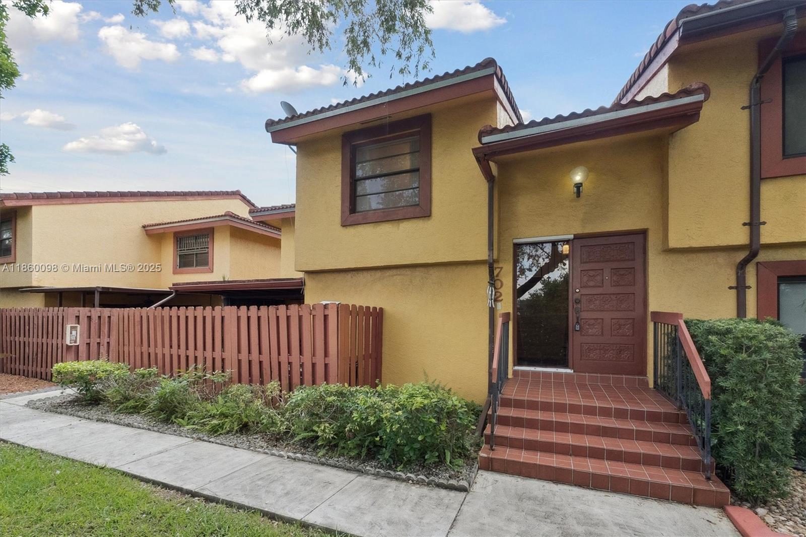 5975 Southwest 137th Avenue, Unit 702 Miami, FL 33183 - Photo 4 of 21 a front view of a house with a garden