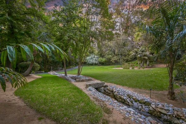 a large kitchen with kitchen island granite countertop a large window cabinets and stainless steel appliances