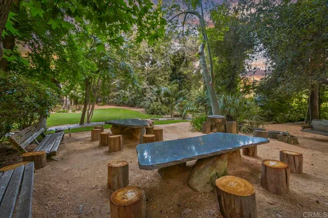 a large kitchen with kitchen island granite countertop a large window cabinets and stainless steel appliances