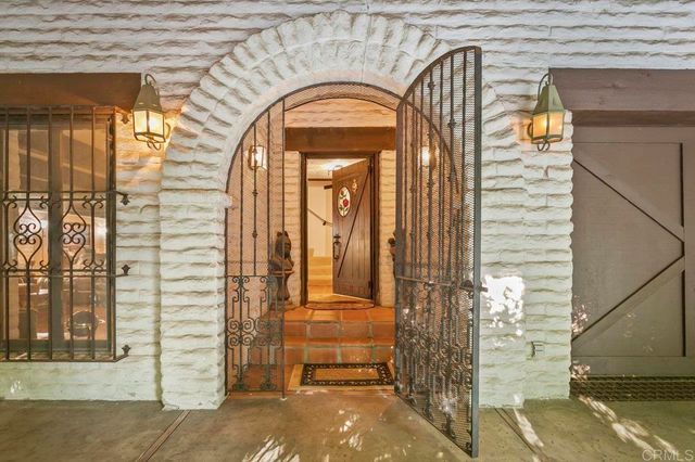 a en suite bathroom with a granite countertop sink and a mirror