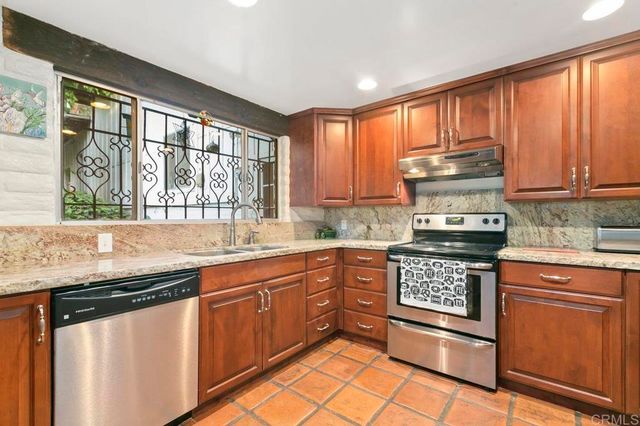 a view of a backyard with plants and a patio