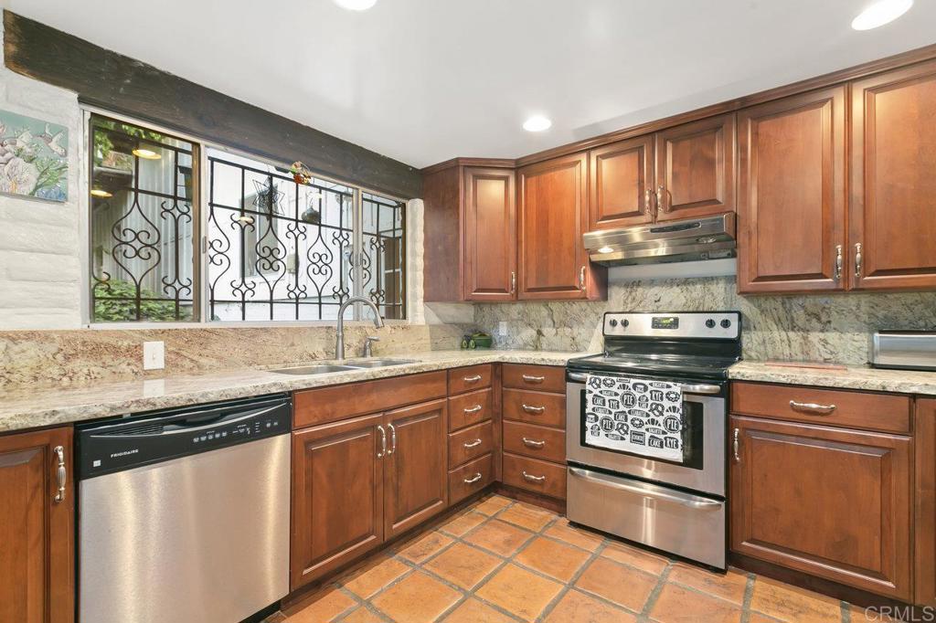 6036 Rainbow Heights Road Fallbrook, CA 92028 - Photo 34 of 70 a kitchen with stainless steel appliances granite countertop a stove a sink and a microwave