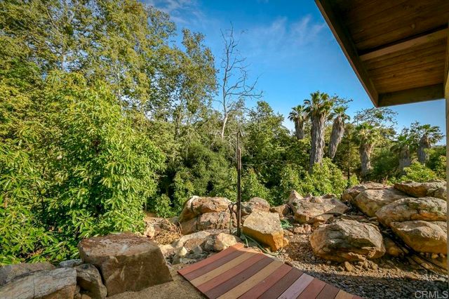 a view of a house with a yard and mountain view