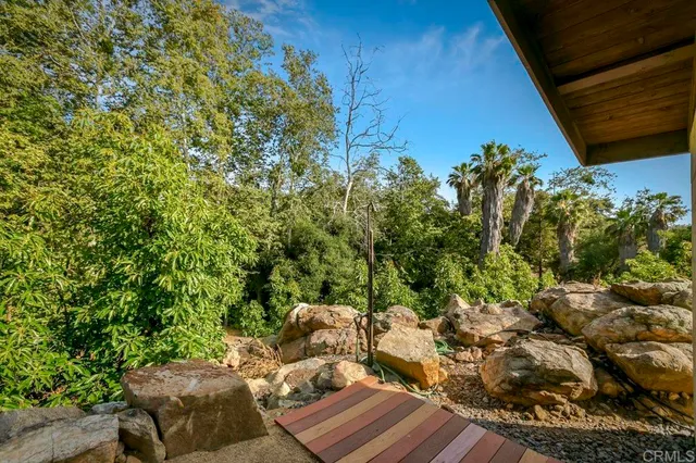 a view of a house with a yard and mountain view